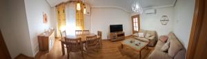 a living room with a couch and a table at Apartamento Poblete in Poblete