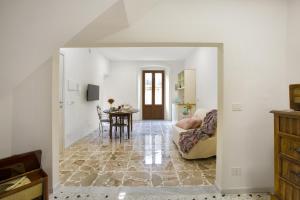 a living room with a couch and a table at Donna Isabella by Armerina Sicily Apartments in Enna +11 photos