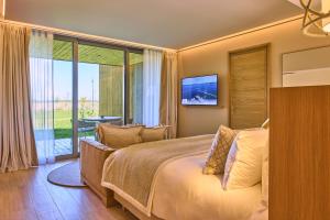 a bedroom with a bed and a sliding glass door at Le Rêve - Hôtel Luxe in Mesnil-Saint-Père