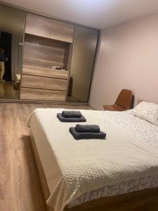 a bedroom with a bed with two towels on it at Апарт Безручка in Rivne