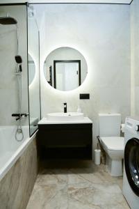 a bathroom with a sink and a toilet and a mirror at Яровиця 9 новобуд in Lutsk