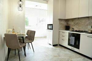 a kitchen with a table and a dining room at Яровиця 9 новобуд in Lutsk