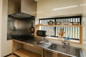 a kitchen with a sink and a counter top at omusubi house 山都町清和文楽Cute Private Cafe-Style House ! One Group Only! in Kamimashiki