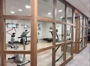 a gym with glass windows and exercise equipment at Les Flanamolo's-Charming apartment luxury complex in Les Gets