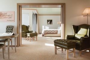a bedroom with a bed and a mirror at Tschuggen Grand Hotel - The Leading Hotels of the World in Arosa