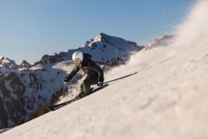a man is skiing down a snow covered slope at Tschuggen Grand Hotel - The Leading Hotels of the World in Arosa