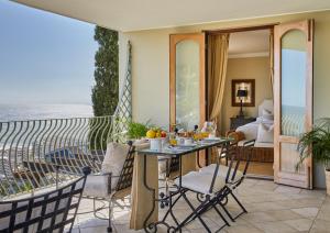 a room with a balcony with a view of the ocean at Villa del Mar - "Luxurious en-suite bedroom with lounge and stunning sea view balcony in Bantry Bay" in Cape Town