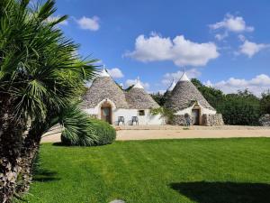 a house with a palm tree in front of it at Tenuta Antico Leccio in Gioia del Colle