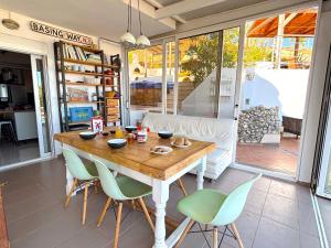 a dining room with a wooden table and chairs at Villa Delta in Fodele