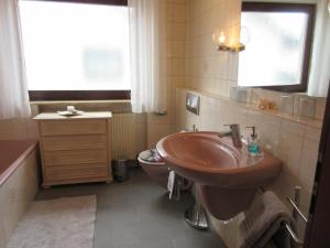 a bathroom with a sink and a toilet at Ferienwohnung Farrnbach in Fürth +17 photos