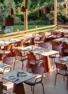 a restaurant with tables and chairs on a patio at Dome Island in Troulos