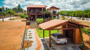 a house with a car parked in front of it at Beautiful house in the paradise of São Cristóvão RN in Areia Branca