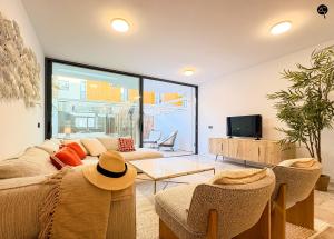 a living room with a couch and a tv at Villa Atenea Grupo AC Gestion in Zahara de los Atunes