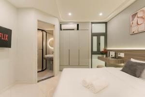a bedroom with a white bed and a bathroom at HoanKiemlake-Oldquarter-Elevator in Hanoi