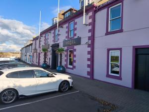 a white car parked in front of a building at The Anchorage in Troon