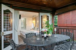 1 dormitorio y patio con mesa y sillas. en Knysna - Meerkat Manor, en Knysna 43 fotos más