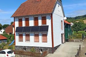 a large white building with a red roof at Ferienwohnung Happy Life in Northeim