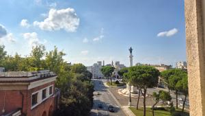 a view of a city street with a tower in the distance at Quinto Piano Panoramic Apartment in the center in Forlì