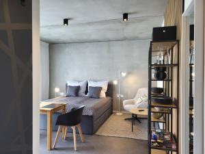 a bedroom with a bed and a table and a chair at Apartment Schlossterrassen 8b in Pouch