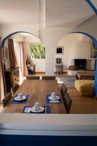 a living room with a large wooden table with two chairs at Majesteuse et Luxieuse Villa à 5 minutes de Monaco in Cap d'Ail