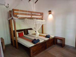 a bedroom with a bunk bed with towels on it at Jackland Holiday Cabanas in Demanhandiya