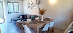 a living room with a table and a couch at Lazur Resort in Rogowo