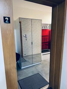 a bathroom with a shower with a glass door at Apartament Nad Nielbą in Wągrowiec +17 photos