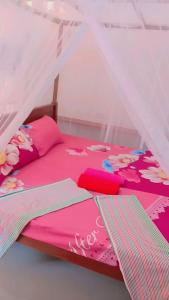 a bedroom with a bed with a canopy at Blooming Mirissa in Mirissa