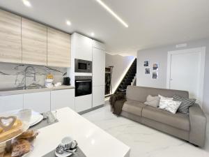 a living room with a couch and a kitchen at LianHome b&b "Terrazzino" in Lucera