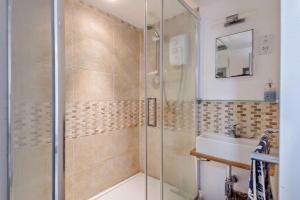 un baño con ducha y lavabo en Salty Dog, en Mundesley