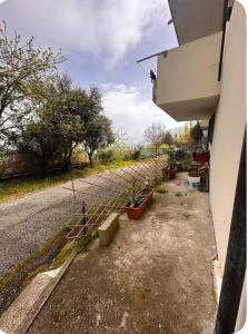 a fence with potted plants on the side of a road at Casa privata in collina in Gemmano