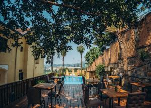 an outdoor patio with tables and chairs and a pool at Eagle View Golf in Kigali