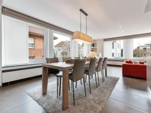 a dining room with a table and chairs at Beachfront Home with Sauna in De Panne +28 photos
