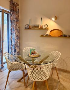a dining room with a glass table and chairs at Twin Homes - Tamerò Estates in Poggio Mirteto