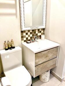 a bathroom with a toilet and a sink and a mirror at Eagles Nest in Kirstenhof +14 photos