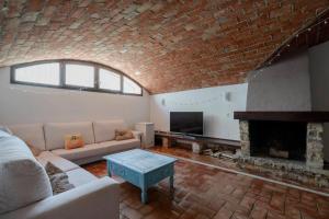 a living room with a couch and a fireplace at Spacious Villa in Granada with Private Pool and Jacuzzi in La Zubia
