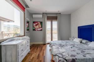 a bedroom with a bed and a dresser and a window at Spacious Villa in Granada with Private Pool and Jacuzzi in La Zubia +93 photos