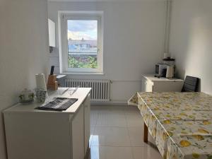 a room with a bed and a desk and a window at K&K Unterkunft Gelsenkirchen in Gelsenkirchen