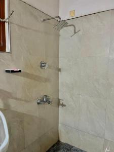 a bathroom with a shower with a sink at Kurundu House Mirissa in Mirissa