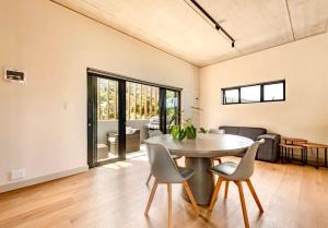 a dining room with a table and chairs at Keursands Luxury Beachside Holiday Escape in Keurboomstrand