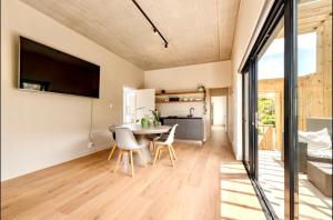 a kitchen and dining room with a table and chairs at Keursands Luxury Beachside Holiday Escape in Keurboomstrand +21 photos