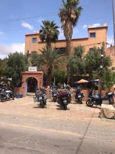 a group of motorcycles parked in front of a building at Auberge Askaoun in Taliouine