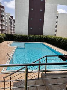 a large blue swimming pool in a building at Stay with queen in Marimbeti