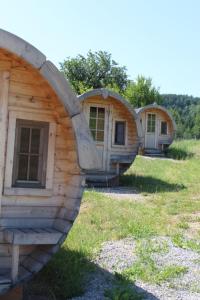 a group of three houses sitting in the grass at Impuls Hof - Unterhegerberg in Stössing +13 photos