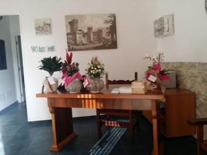 a wooden table with vases of flowers on it at Al Giardino di Anna in Fondi
