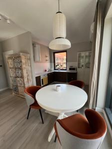 a dining room with a white table and chairs at Legnica4 in Legnica