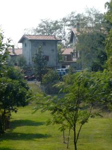 a house in the middle of a green yard at Cascina Cologna in Galbiate