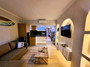 a living room with a couch and a table at Mana Suites Bali in Kuta