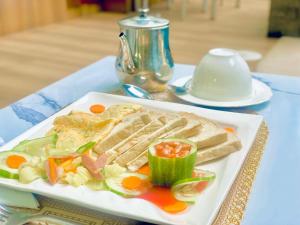 a white plate of food on a table at Presken Hotel Castle, Opebi Lagos in Lagos