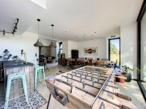 a room with a table with a bunch of swords at Villa Wapiti Small in Aywaille